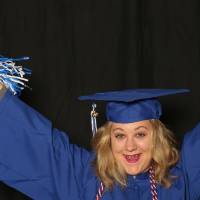 soon to be graduate using pom poms as a prop
